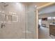 White marble shower featuring built-in seat and shelving at 1912 Glenview Dr, Las Vegas, NV 89134
