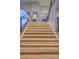 Elegant staircase illuminated with LED lighting, showcasing wooden steps and a sleek glass railing at 1912 Glenview Dr, Las Vegas, NV 89134