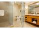 Bathroom featuring a glass shower and vanity with a mirror and gold frame at 2000 Fashion Show Dr # 2604, Las Vegas, NV 89109