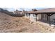 View of the backyard and the covered patio from the side at 2222 Little River Ct, Las Vegas, NV 89156