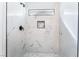 Elegant shower with marble tiling, built-in bench, and a contemporary showerhead, offering a luxurious bathing experience at 2222 Little River Ct, Las Vegas, NV 89156