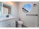 Modern bathroom featuring a unique round window, sleek vanity, and contemporary fixtures at 2222 Little River Ct, Las Vegas, NV 89156