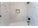 Stylish bathroom with marble tile surround, black fixtures, and a deep soaking tub at 2222 Little River Ct, Las Vegas, NV 89156