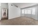 Inviting bedroom featuring neutral carpeting and views through multiple windows at 2222 Little River Ct, Las Vegas, NV 89156