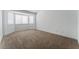 Spacious bedroom with plush carpeting, multiple windows and ample natural light at 2222 Little River Ct, Las Vegas, NV 89156