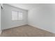 Sunlit bedroom with neutral carpet and large window at 2222 Little River Ct, Las Vegas, NV 89156