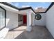 Covered entrance with stately columns and a bright red front door at 2222 Little River Ct, Las Vegas, NV 89156
