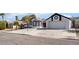 Inviting home with well-maintained lawn, desert landscaping, and large driveway at 2222 Little River Ct, Las Vegas, NV 89156