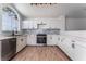 Bright kitchen features white cabinetry, stainless steel appliances, and modern track lighting at 2222 Little River Ct, Las Vegas, NV 89156