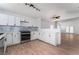 Open concept kitchen features stainless steel appliances, modern lighting and seamless flow to living area at 2222 Little River Ct, Las Vegas, NV 89156