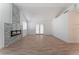 Bright living room with a modern fireplace, wood flooring, and French doors at 2222 Little River Ct, Las Vegas, NV 89156