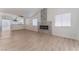 Open-concept living room with modern fireplace and views to kitchen at 2222 Little River Ct, Las Vegas, NV 89156