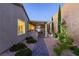 Beautiful backyard space with covered patio, outdoor kitchen, and manicured landscaping create an ideal outdoor retreat at 2341 Rosendale Village Ave, Henderson, NV 89052