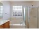 Bathroom features a tub, glass block window, and shower at 2341 Rosendale Village Ave, Henderson, NV 89052