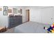 Comfortable bedroom featuring a full bed, carpet, and a dresser at 2341 Rosendale Village Ave, Henderson, NV 89052