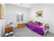 Bright bedroom with a twin bed, carpet, and a sunny window at 2341 Rosendale Village Ave, Henderson, NV 89052