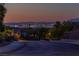 Neighborhood street with a view of the city skyline in the distance at 2341 Rosendale Village Ave, Henderson, NV 89052