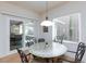 Cozy dining area with sliding door access to backyard, features a pendant light and comfortable seating at 2341 Rosendale Village Ave, Henderson, NV 89052