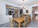 The dining room presents a wood table with floral chairs under a chandelier, adjacent to an open-concept space at 2341 Rosendale Village Ave, Henderson, NV 89052