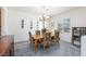 Inviting dining room features a chandelier and stylish floral upholstered chairs around the wooden table at 2341 Rosendale Village Ave, Henderson, NV 89052