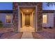 Inviting front entrance with stone accents and a covered porch at 2341 Rosendale Village Ave, Henderson, NV 89052