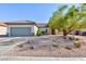 Single story home with desert landscaping, tile roof, and a two car garage at 2341 Rosendale Village Ave, Henderson, NV 89052