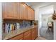 Spacious kitchen boasts granite countertops and ample wooden cabinets for storage at 2341 Rosendale Village Ave, Henderson, NV 89052