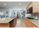 Modern kitchen with granite countertops, stainless steel appliances, and ample cabinet space for storage at 2341 Rosendale Village Ave, Henderson, NV 89052