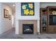 Cozy living room fireplace with tiled surround, built-in shelving and carpet at 2341 Rosendale Village Ave, Henderson, NV 89052