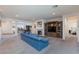 Spacious living room features a fireplace, media center, and a comfortable blue sofa, creating an inviting atmosphere at 2341 Rosendale Village Ave, Henderson, NV 89052