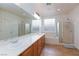 Bright bathroom featuring double sinks, a separate shower, and a luxurious bathtub at 2341 Rosendale Village Ave, Henderson, NV 89052
