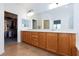Spacious main bathroom with double sinks, wood cabinets, and a walk-in closet at 2341 Rosendale Village Ave, Henderson, NV 89052