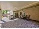An inviting outdoor dining area under a covered patio with a built-in grill and a dining table set for six at 2341 Rosendale Village Ave, Henderson, NV 89052