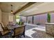 Covered patio with brick flooring, a dining table, and outdoor seating at 2341 Rosendale Village Ave, Henderson, NV 89052