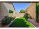 A backyard putting green offers a fun recreational amenity, surrounded by tasteful landscaping and privacy walls at 2341 Rosendale Village Ave, Henderson, NV 89052