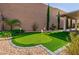 Backyard putting green providing a recreational amenity with manicured turf and privacy wall at 2341 Rosendale Village Ave, Henderson, NV 89052