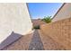 A neatly landscaped side yard with gravel and pavers, providing a clean and low-maintenance outdoor space at 2341 Rosendale Village Ave, Henderson, NV 89052