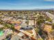 A suburban home with a well-kept yard and mature trees offers an ideal blend of tranquility and accessibility to city conveniences at 2450 Tournament St, Las Vegas, NV 89142