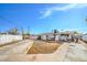 Spacious backyard with gravel landscape, hardscape, and a white fence around the perimeter at 2450 Tournament St, Las Vegas, NV 89142
