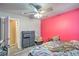 Cozy bedroom featuring a ceiling fan, pink accent wall, and plenty of natural light at 2450 Tournament St, Las Vegas, NV 89142