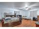 This large bedroom features wood floors, two beds, a ceiling fan, and two large windows at 2450 Tournament St, Las Vegas, NV 89142