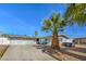 Charming single story home featuring a xeriscaped front yard and a long driveway leading to an attached garage at 2450 Tournament St, Las Vegas, NV 89142