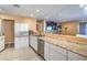 An open kitchen features a granite countertop, stainless steel appliances, and white cabinets at 2450 Tournament St, Las Vegas, NV 89142