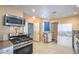 Kitchen features granite countertops, white cabinets, new stainless steel appliances and tile floors at 2450 Tournament St, Las Vegas, NV 89142