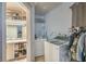 This laundry room features tile floors, overhead shelving, and a side entrance to the bathroom at 2450 Tournament St, Las Vegas, NV 89142