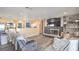 Living room featuring fireplace, laminate wood flooring, open concept to kitchen and neutral colored walls at 2450 Tournament St, Las Vegas, NV 89142