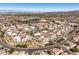 This aerial shot captures the community's layout with nearby amenities, landscaping, and a backdrop of distant mountains at 2555 Hampton Rd # 4204, Henderson, NV 89052