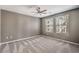 A carpeted bedroom with a ceiling fan and bright windows providing natural light at 2555 Hampton Rd # 4204, Henderson, NV 89052