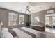 Serene bedroom with a ceiling fan, large windows, and a workspace, offering comfort and functionality at 2555 Hampton Rd # 4204, Henderson, NV 89052