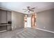 A carpeted bedroom featuring a ceiling fan, windows, workspace and ensuite bathroom at 2555 Hampton Rd # 4204, Henderson, NV 89052